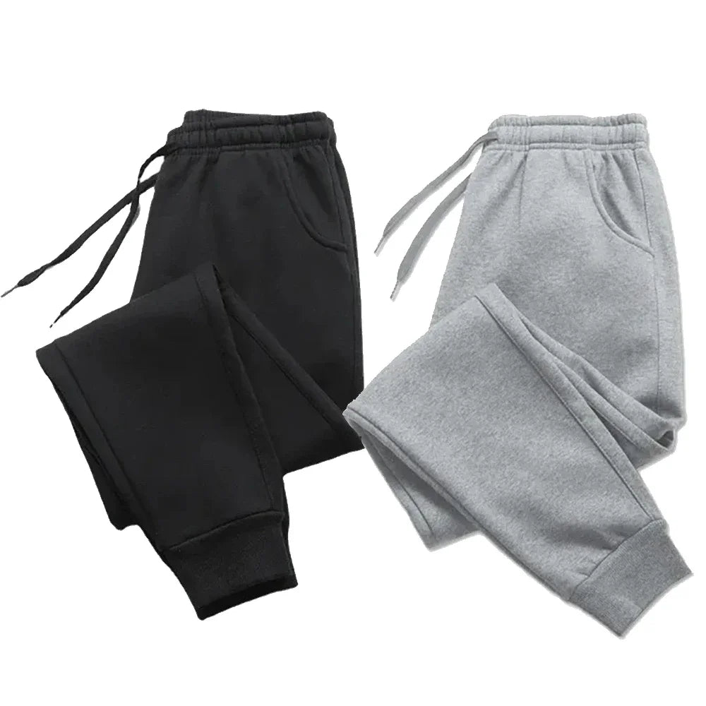 Fleece sweatpants in black and gray, designed for autumn and winter. Cozy and stylish joggers with an adjustable drawstring and ribbed cuffs.