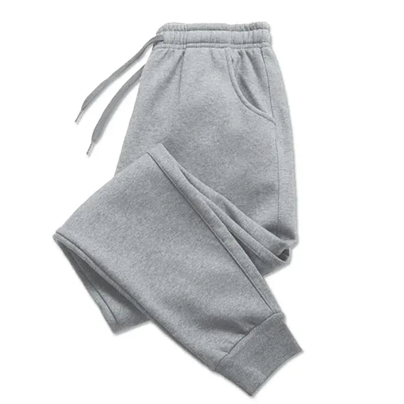 Cozy and stylish fleece sweatpants in light gray, perfect for autumn and winter. Features an adjustable drawstring waist, side pockets, and ribbed cuffs.
