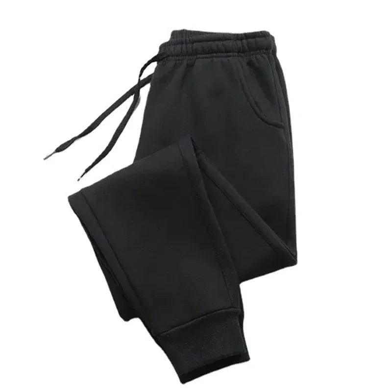 Black fleece sweatpants with an adjustable drawstring and ribbed cuffs, perfect for autumn and winter. Cozy and stylish joggers for casual wear.