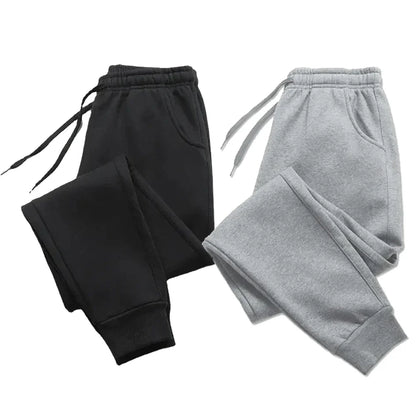 Fleece sweatpants in black and gray, designed for autumn and winter. Cozy and stylish joggers with an adjustable drawstring and ribbed cuffs.